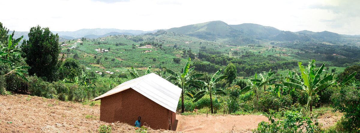 Rural highland landscape with traditional house and green hills in Bushenyi District, western Uganda
